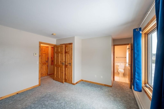 unfurnished bedroom featuring baseboards and carpet floors