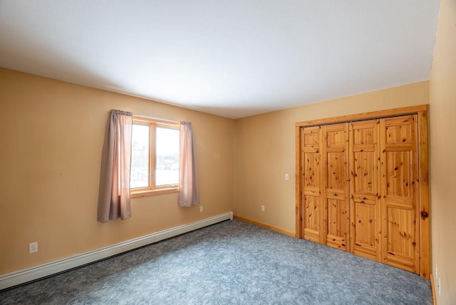 unfurnished bedroom with carpet flooring, baseboards, and baseboard heating