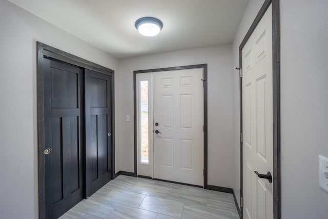 entryway featuring baseboards