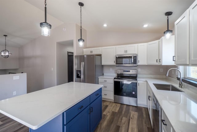 kitchen with lofted ceiling, appliances with stainless steel finishes, dark wood-style floors, white cabinetry, and a sink