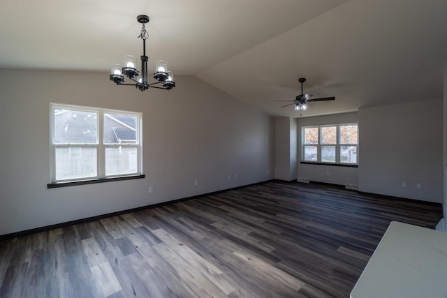 unfurnished room with lofted ceiling, visible vents, dark wood-type flooring, and baseboards