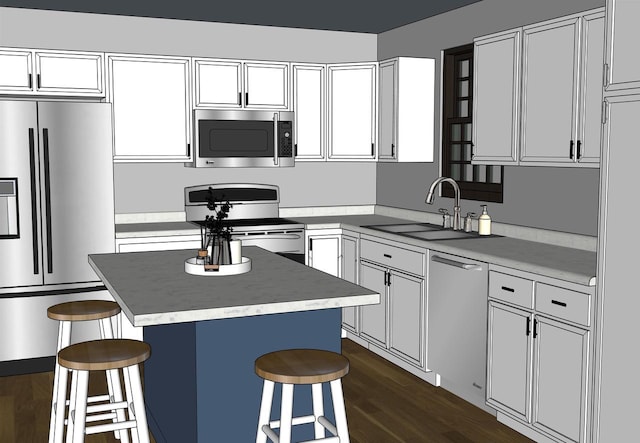 kitchen with a breakfast bar, dark wood finished floors, stainless steel appliances, and a sink