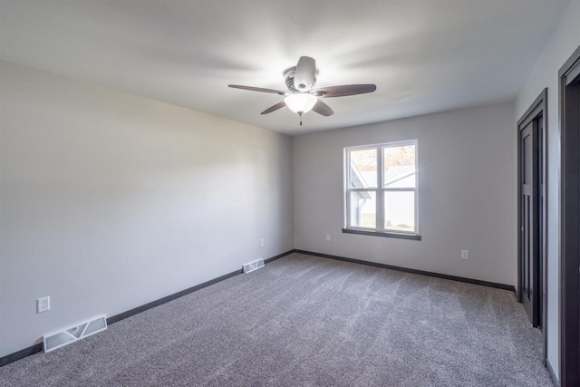 spare room with visible vents, baseboards, carpet, and ceiling fan