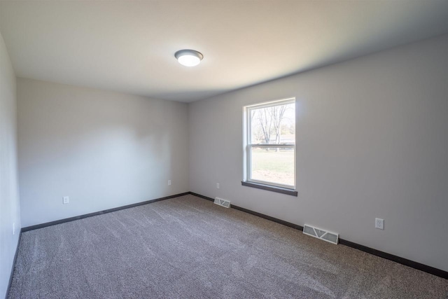 unfurnished room featuring visible vents, baseboards, and carpet floors