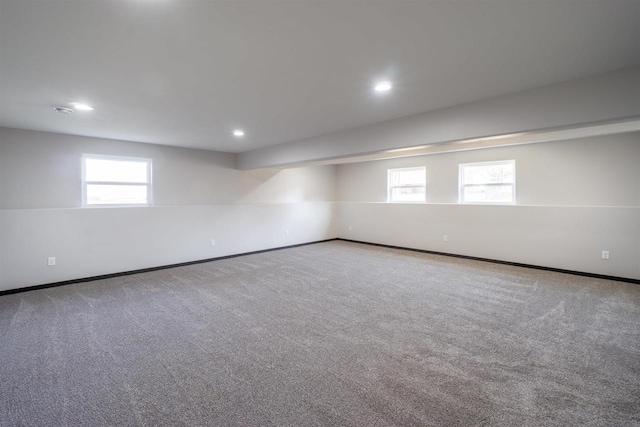 carpeted spare room with plenty of natural light, recessed lighting, and baseboards