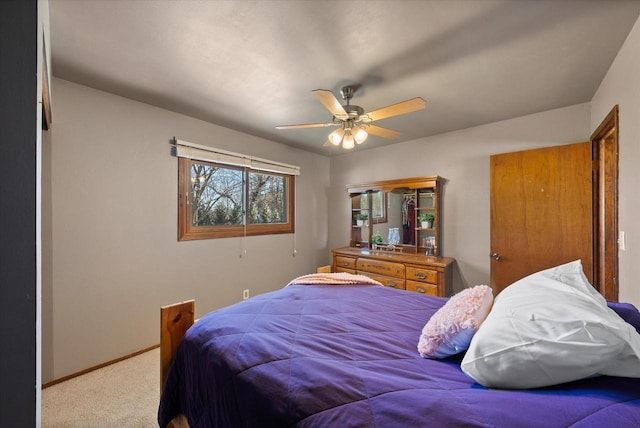 bedroom with ceiling fan, baseboards, and carpet