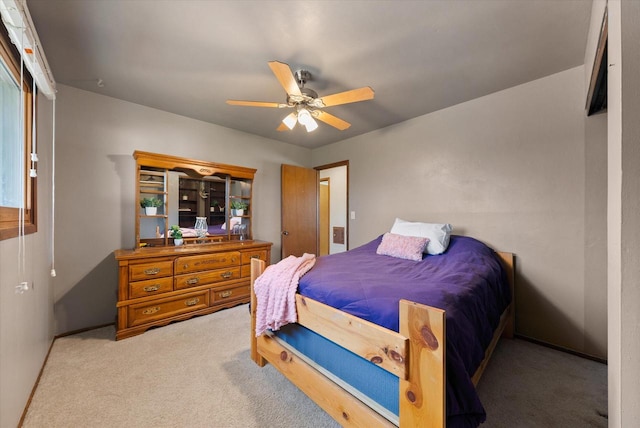 bedroom with ceiling fan and carpet flooring