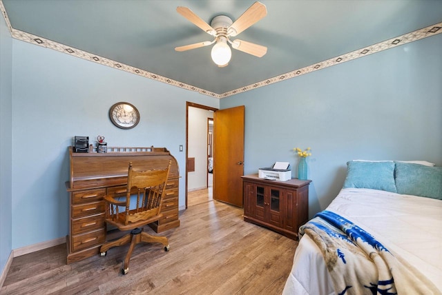 bedroom featuring wood finished floors, baseboards, and ceiling fan