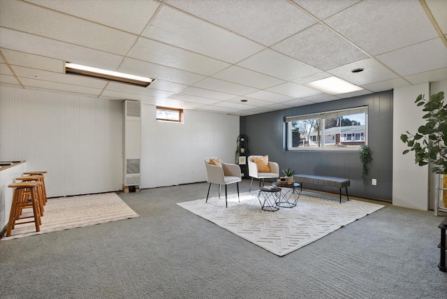 sitting room with carpet and a drop ceiling