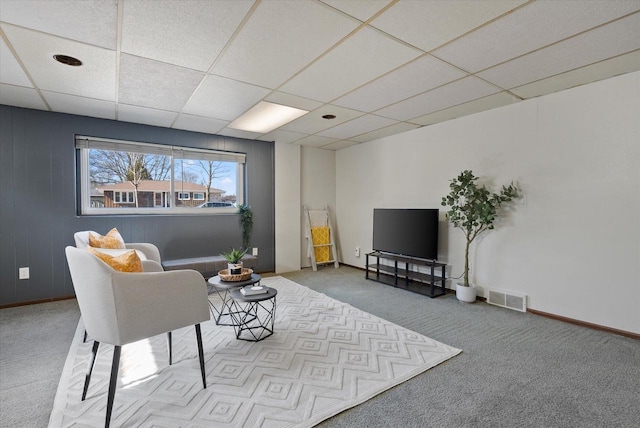 interior space with visible vents, baseboards, and a drop ceiling