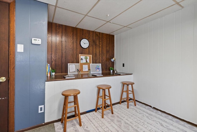 kitchen featuring a paneled ceiling and a breakfast bar