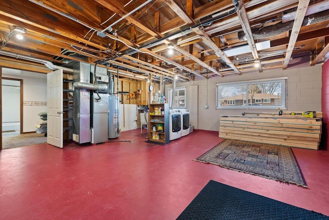 basement featuring washing machine and clothes dryer, heating unit, gas water heater, and concrete block wall