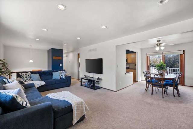 living room featuring recessed lighting, visible vents, light carpet, and baseboards