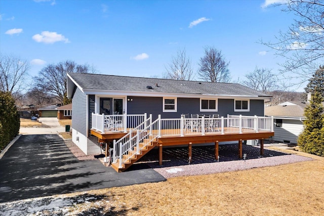 back of house with stairway, aphalt driveway, a deck, and a shingled roof