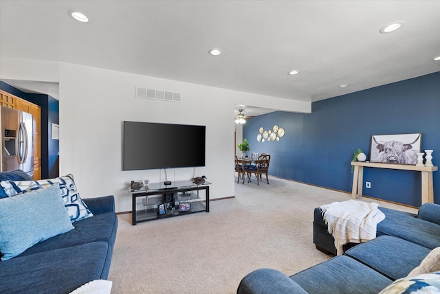 carpeted living area with recessed lighting, visible vents, and baseboards