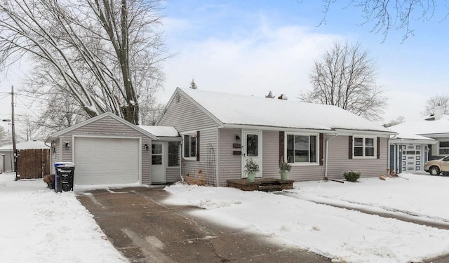 ranch-style house with a garage and driveway