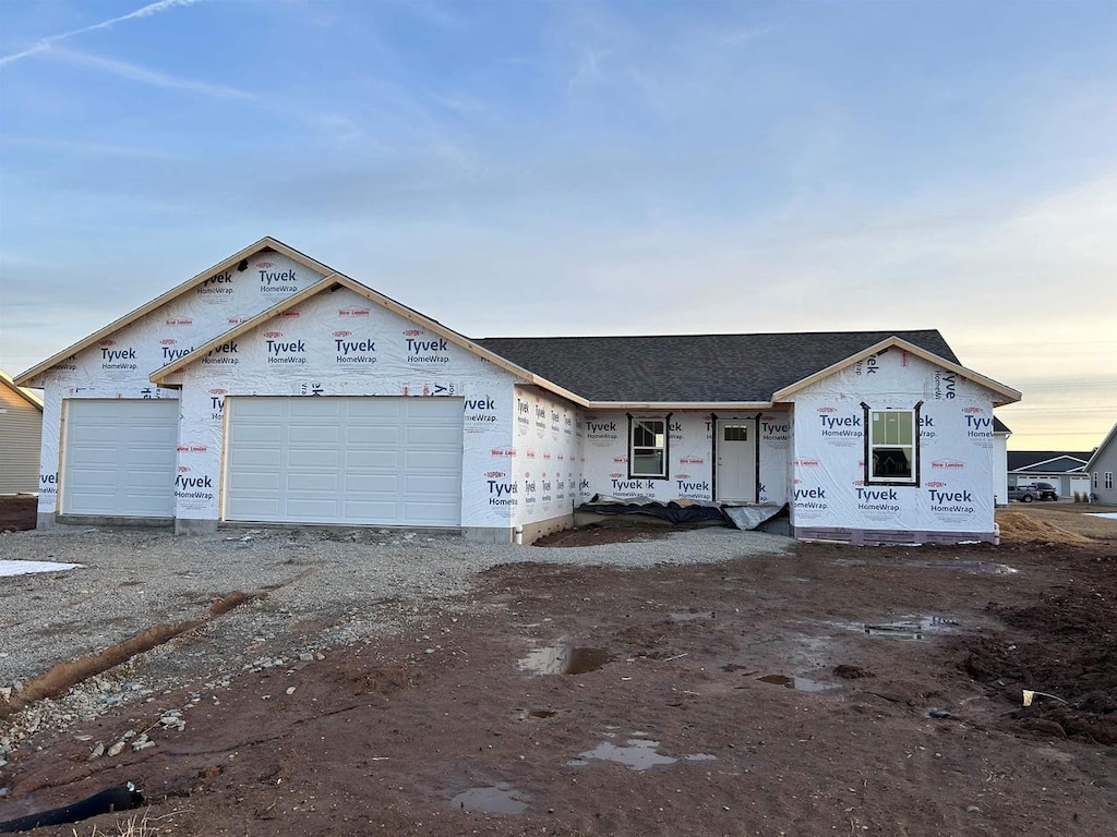 property in mid-construction with an attached garage and driveway