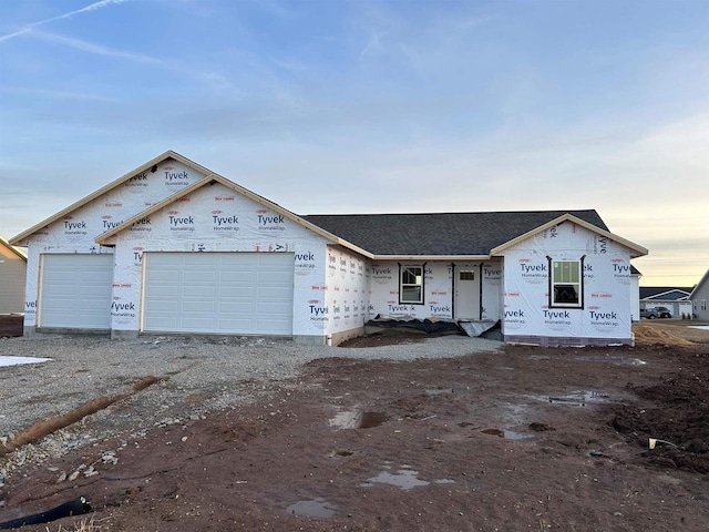 property in mid-construction with an attached garage and driveway