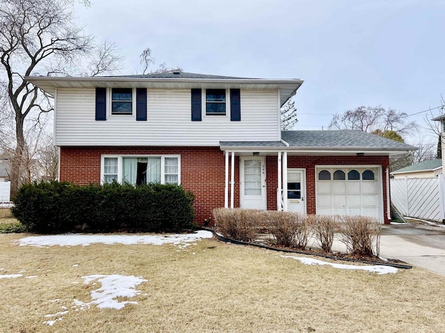246 Taft St, Fond Du Lac, WI 54935 - view of front of home with an attached garage, concrete driveway, brick siding, a front yard, and roof with shingles