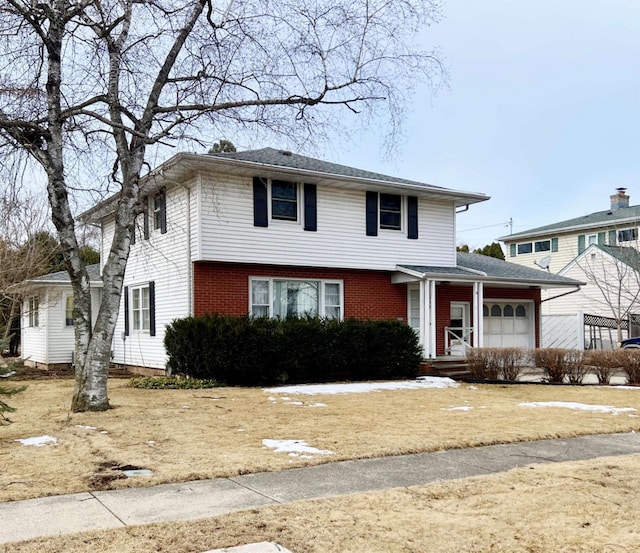 view of front facade featuring a garage and brick siding