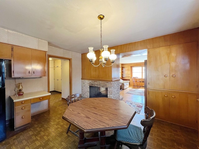 dining room featuring a fireplace and a chandelier