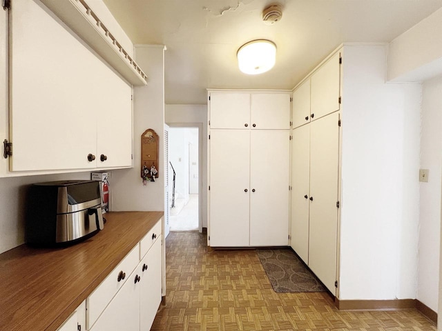 kitchen featuring white cabinets