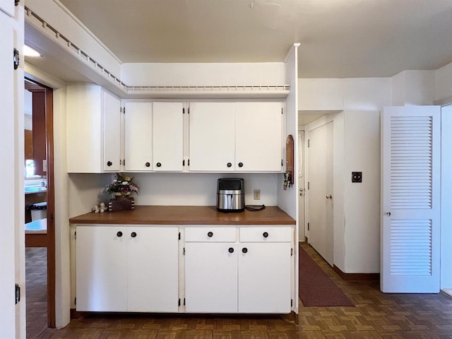 kitchen featuring dark countertops and white cabinets