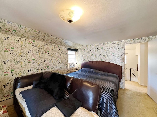 carpeted bedroom with wallpapered walls