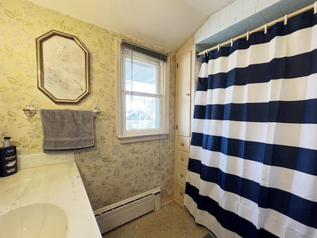 full bathroom featuring wallpapered walls, a baseboard heating unit, a shower with shower curtain, vaulted ceiling, and a sink