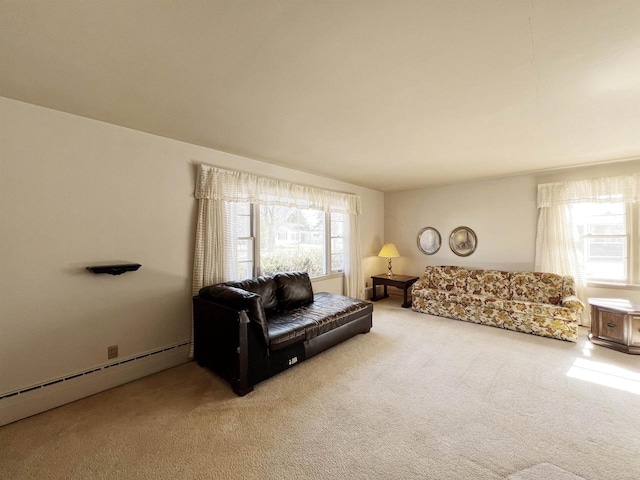 living room with a baseboard heating unit and light colored carpet