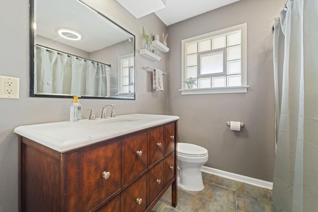 full bath featuring tile patterned floors, baseboards, toilet, and vanity