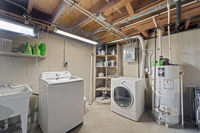 washroom with gas water heater, independent washer and dryer, laundry area, and a sink