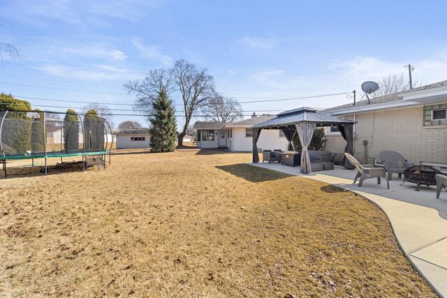 view of yard with a gazebo, a patio, a trampoline, and an outdoor living space with a fire pit