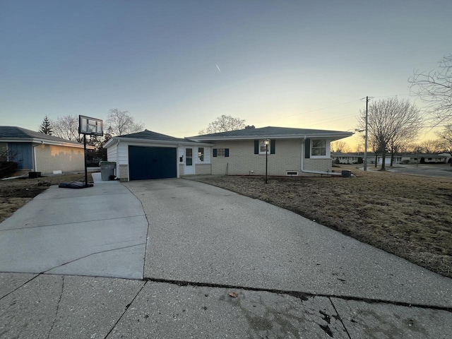 view of front of property featuring brick siding, driveway, an outdoor structure, and a garage