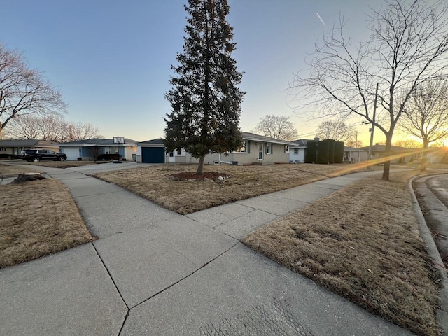 ranch-style home with an attached garage and driveway