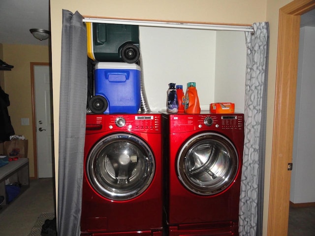 clothes washing area with washer and clothes dryer and laundry area