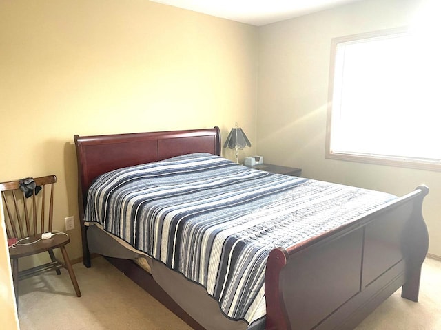 carpeted bedroom featuring baseboards