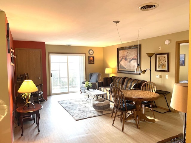 living room with visible vents and wood finished floors