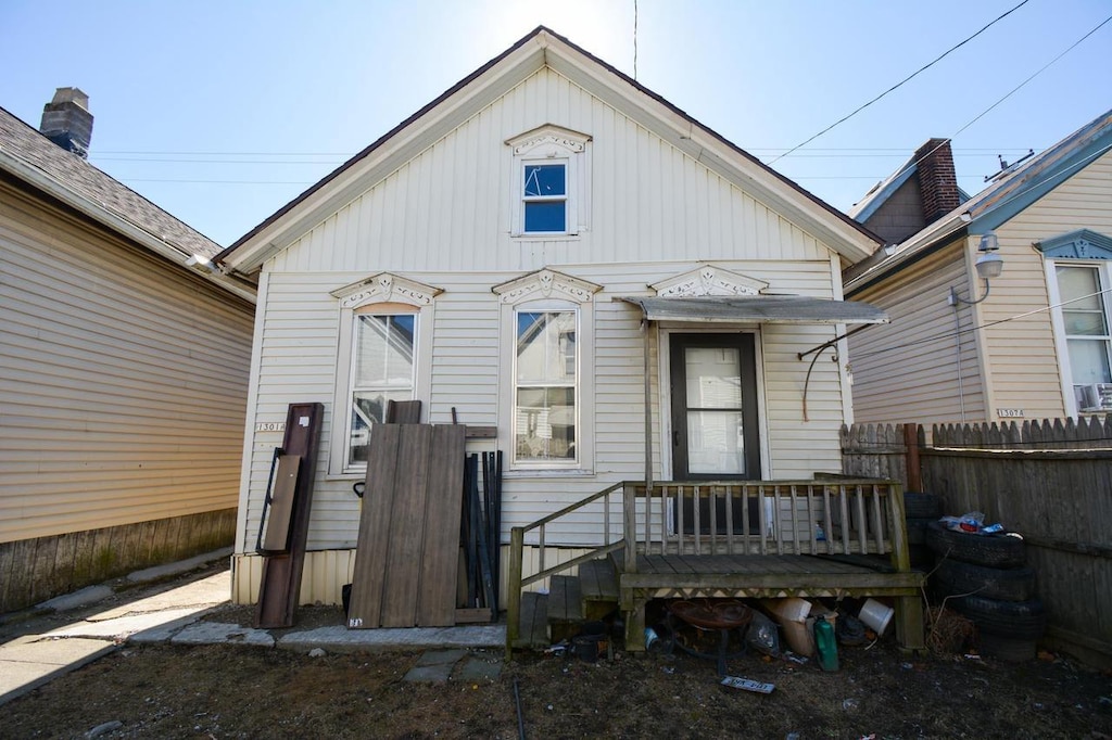 back of house with fence