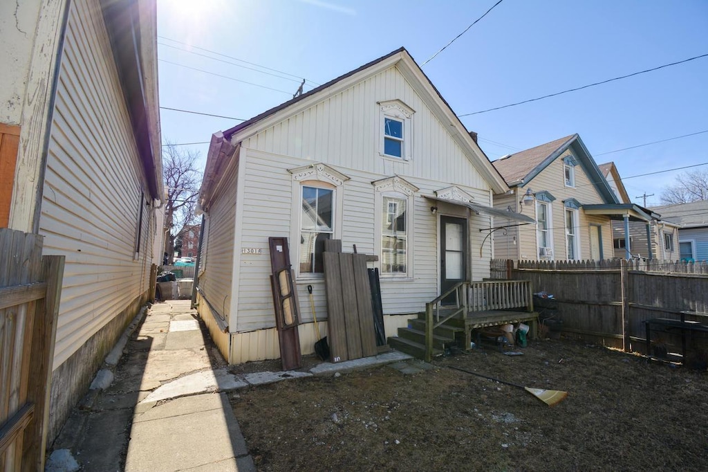 back of house featuring fence