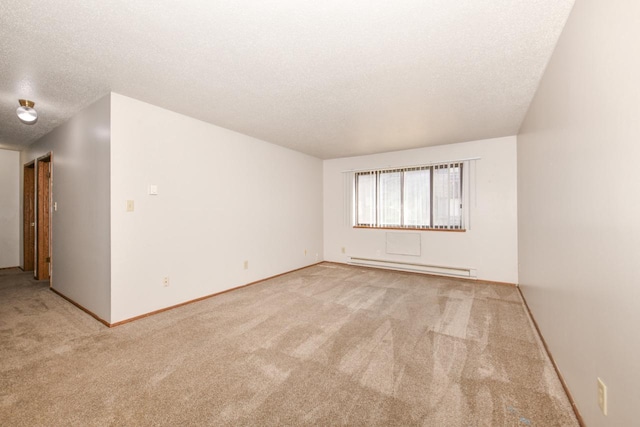 empty room featuring carpet floors, a textured ceiling, baseboards, and a baseboard radiator