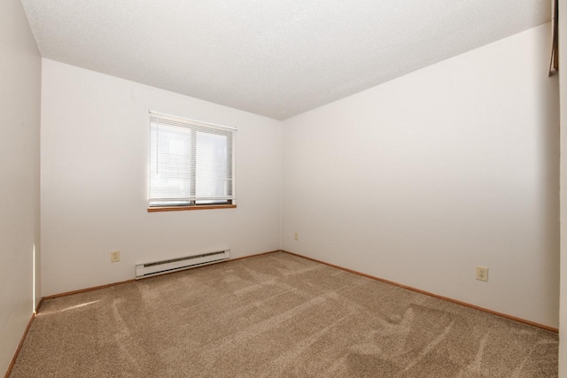 spare room featuring light colored carpet, baseboards, and baseboard heating