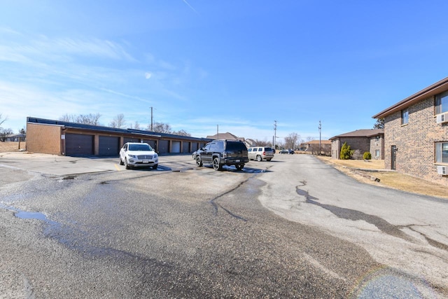 view of road featuring community garages