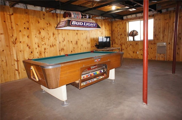 recreation room with pool table, wood walls, and concrete floors