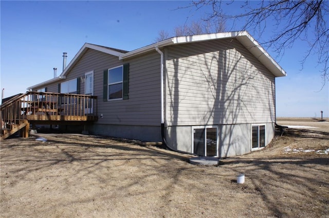 view of property exterior with a wooden deck