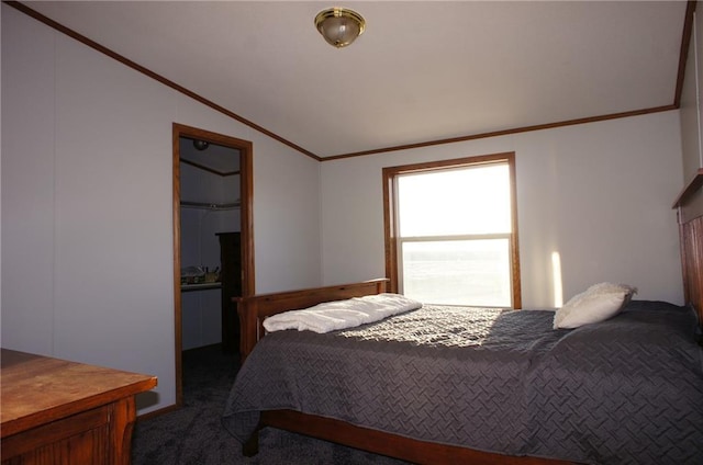 carpeted bedroom with crown molding and vaulted ceiling