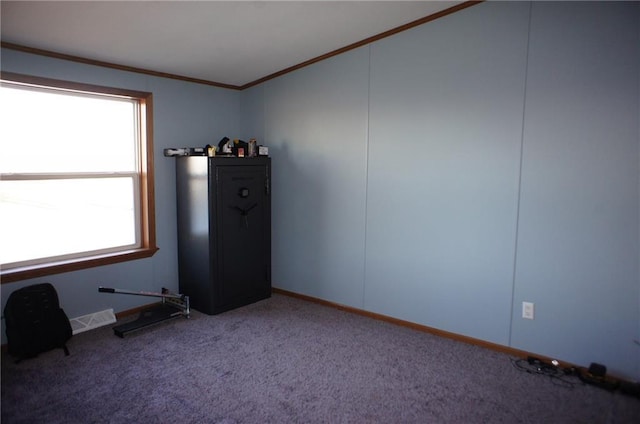 carpeted empty room with visible vents, baseboards, and crown molding