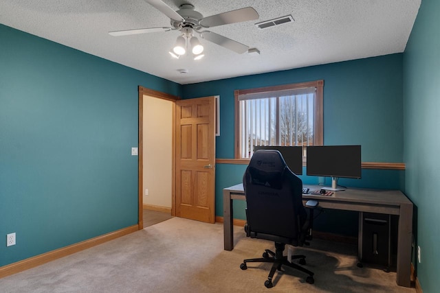 home office featuring visible vents, ceiling fan, baseboards, carpet floors, and a textured ceiling