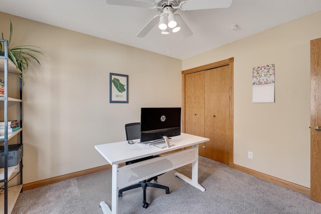 office space with light carpet, ceiling fan, and baseboards