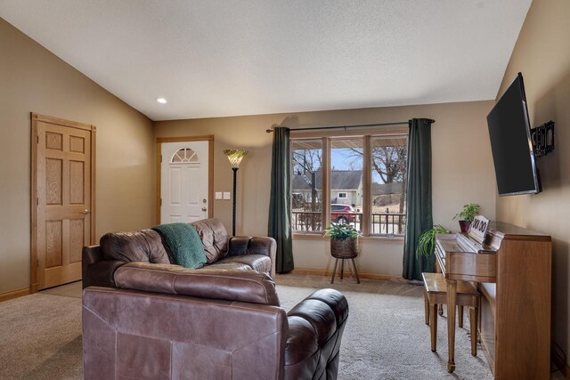 living room featuring light carpet, baseboards, and lofted ceiling